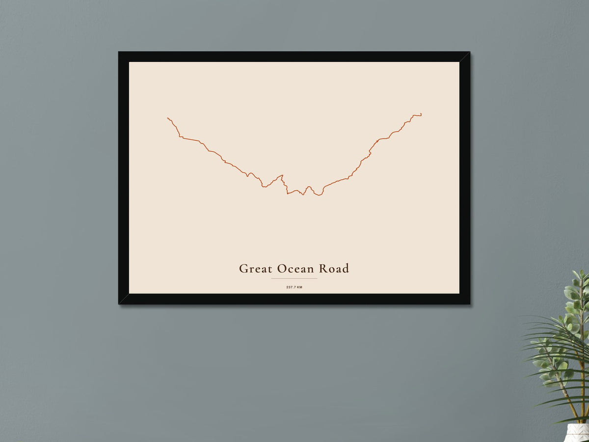 A route poster in a black frame on a living room wall