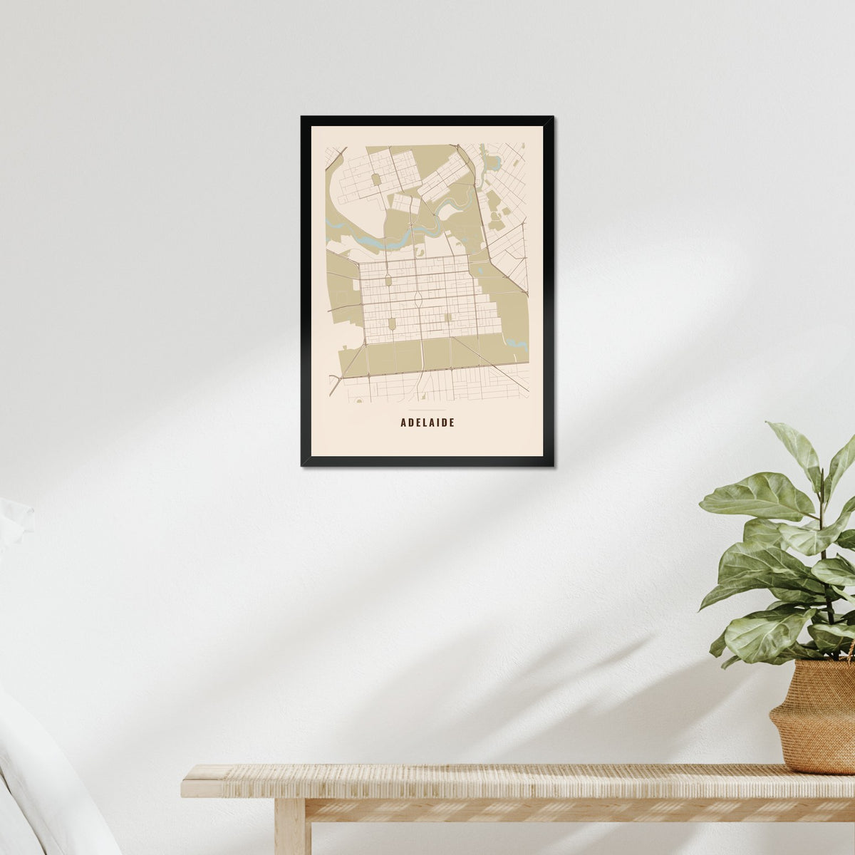 Adelaide City Map poster in a black frame above a bed
