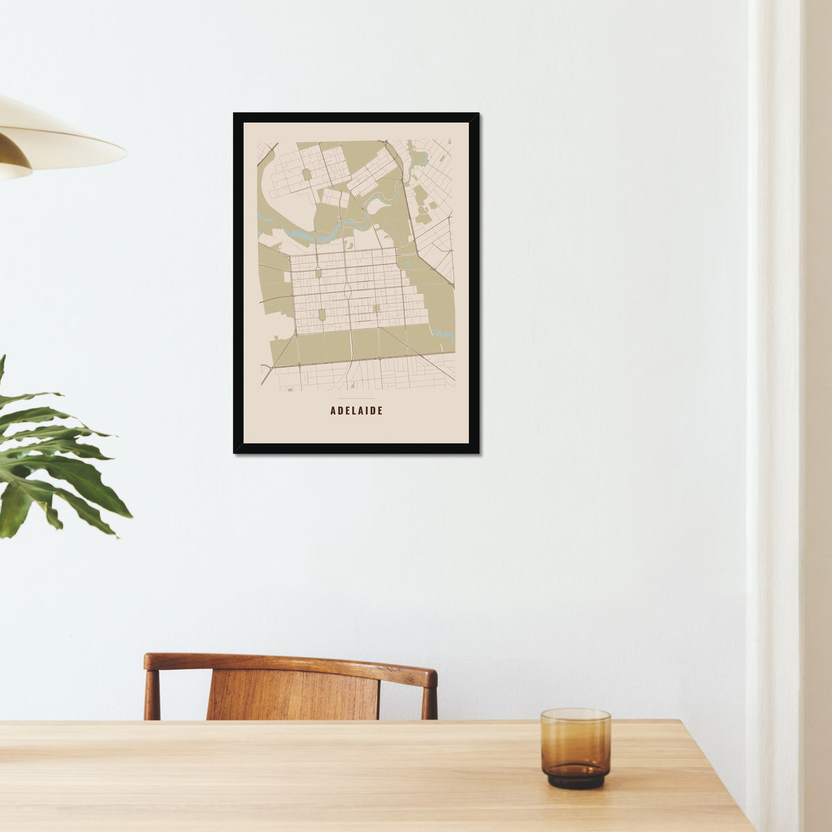 Adelaide City Map poster in a black frame on a dining room wall