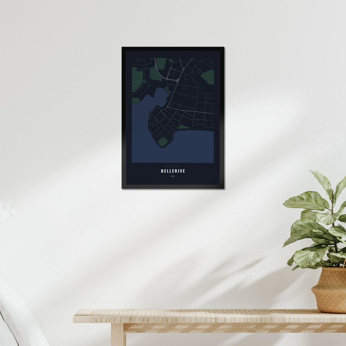 Bellerive Map poster in a black frame above a bed