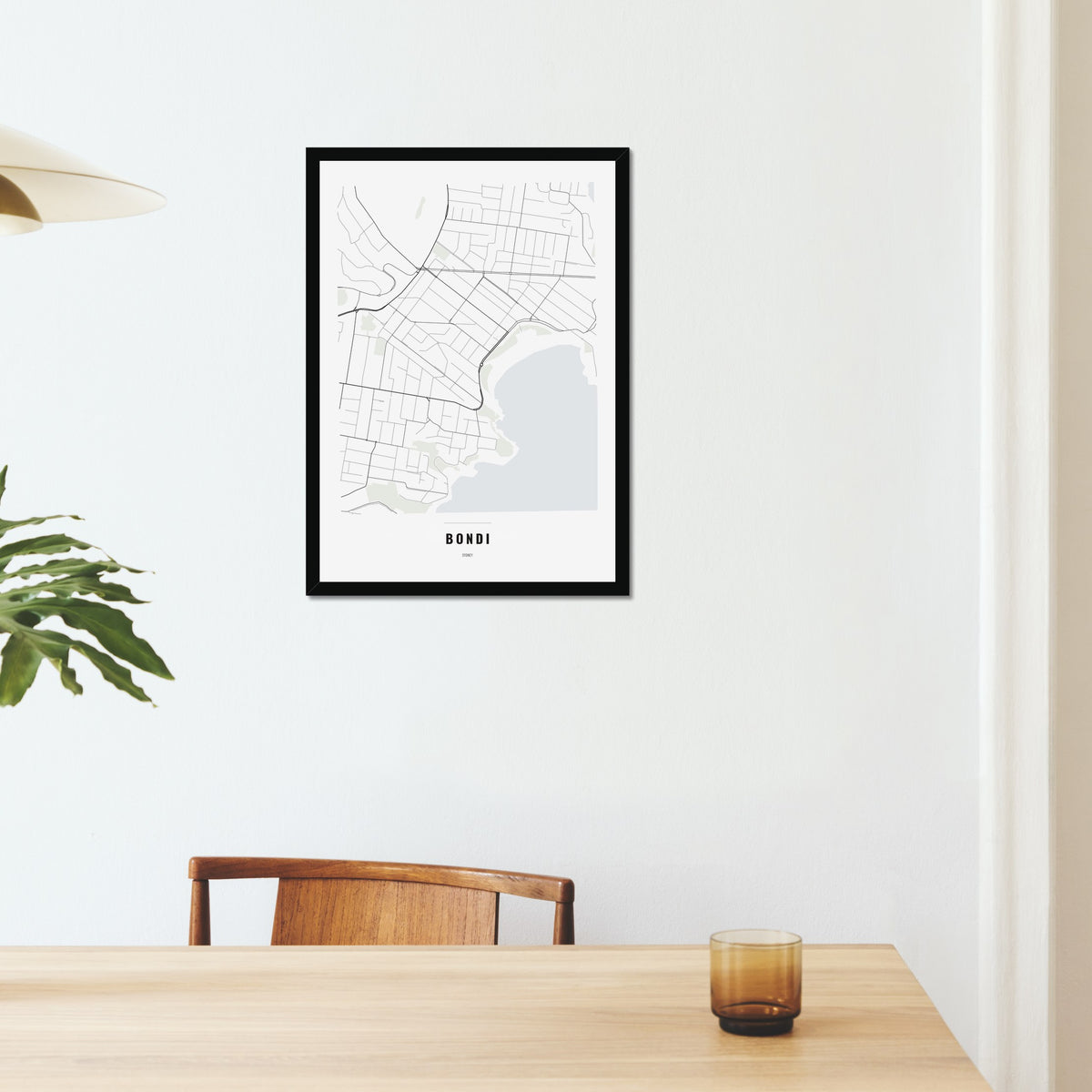 Bondi Map poster in a black frame on a dining room wall