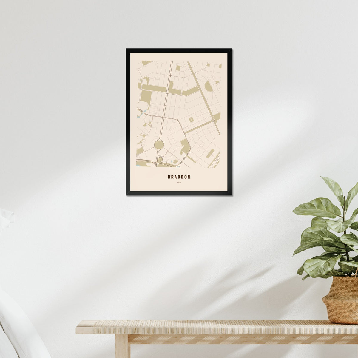 Braddon Map poster in a black frame above a bed