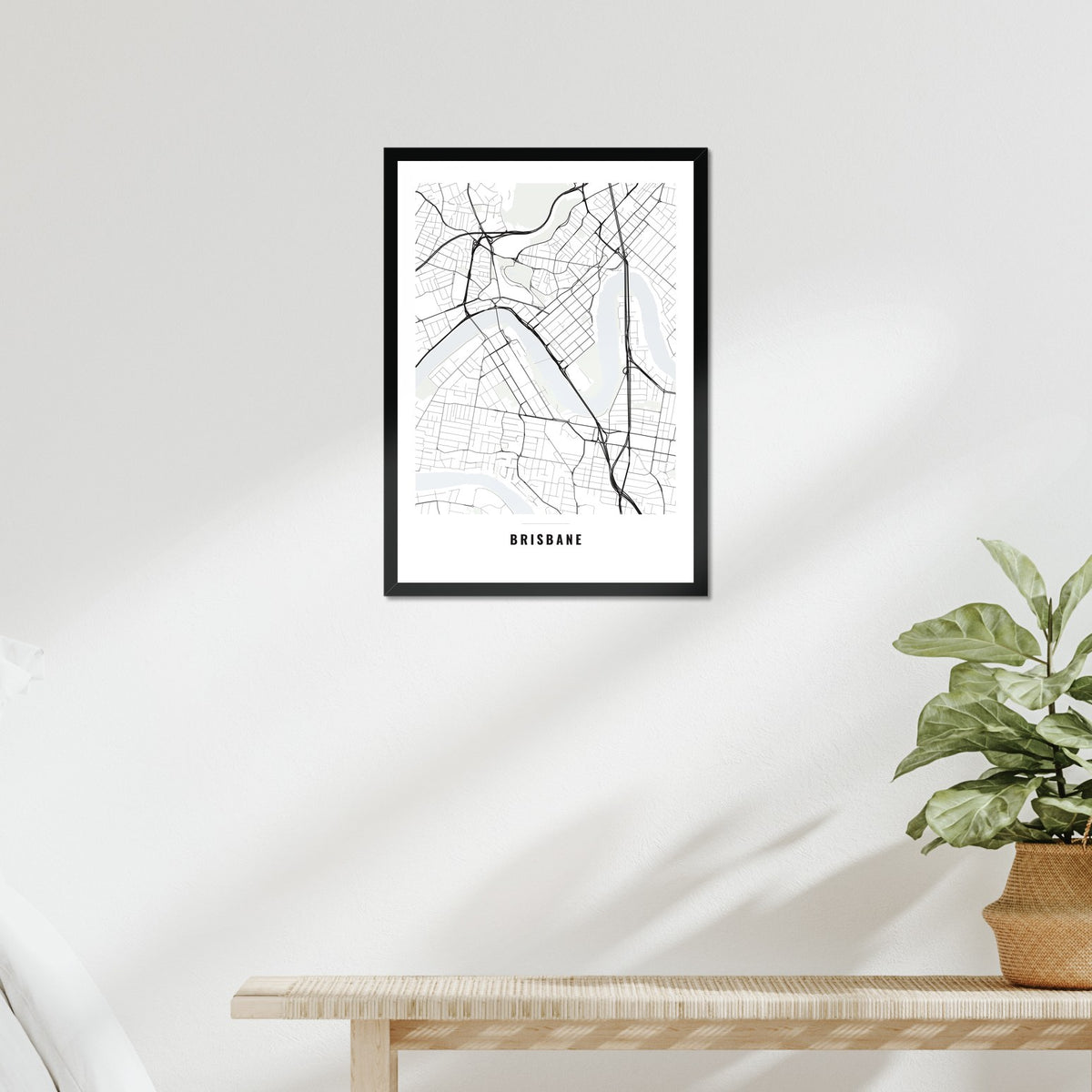 Brisbane City Map poster in a black frame above a bed
