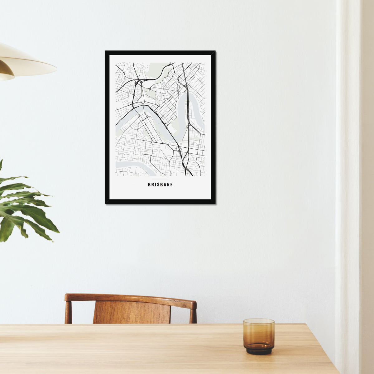 Brisbane City Map poster in a black frame on a dining room wall