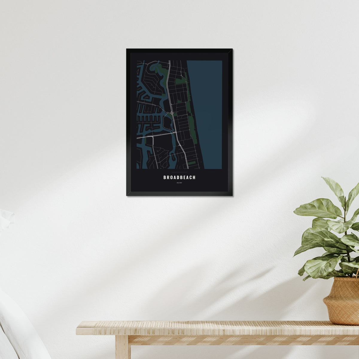 Broadbeach Map poster in a black frame above a bed