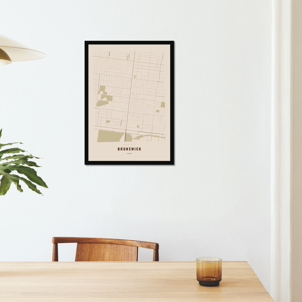Brunswick Map poster in a black frame on a dining room wall