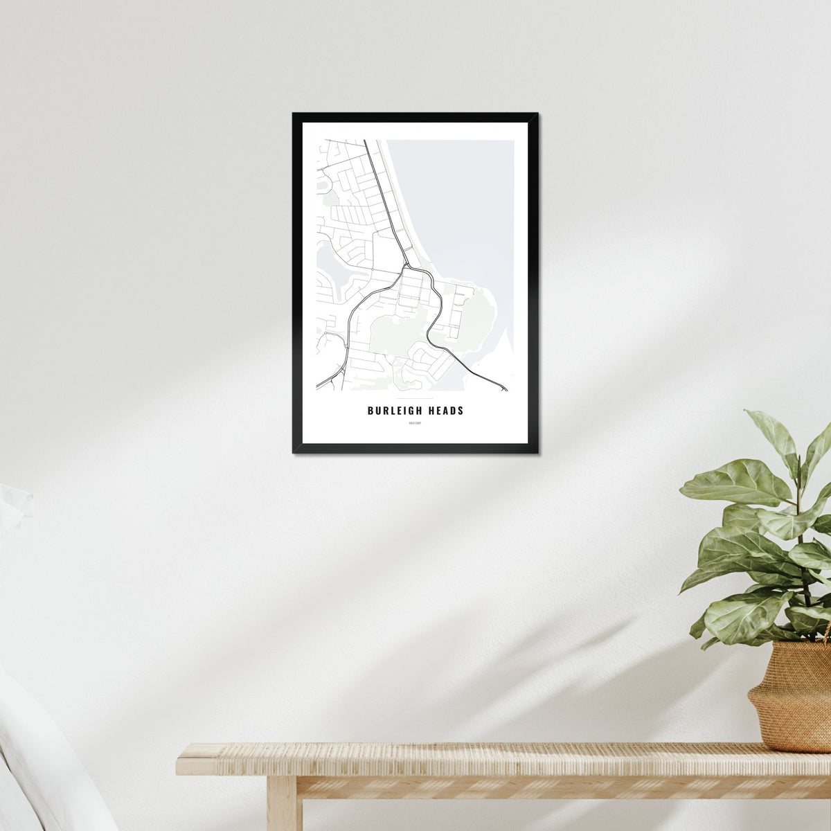Burleigh Heads Map poster in a black frame above a bed