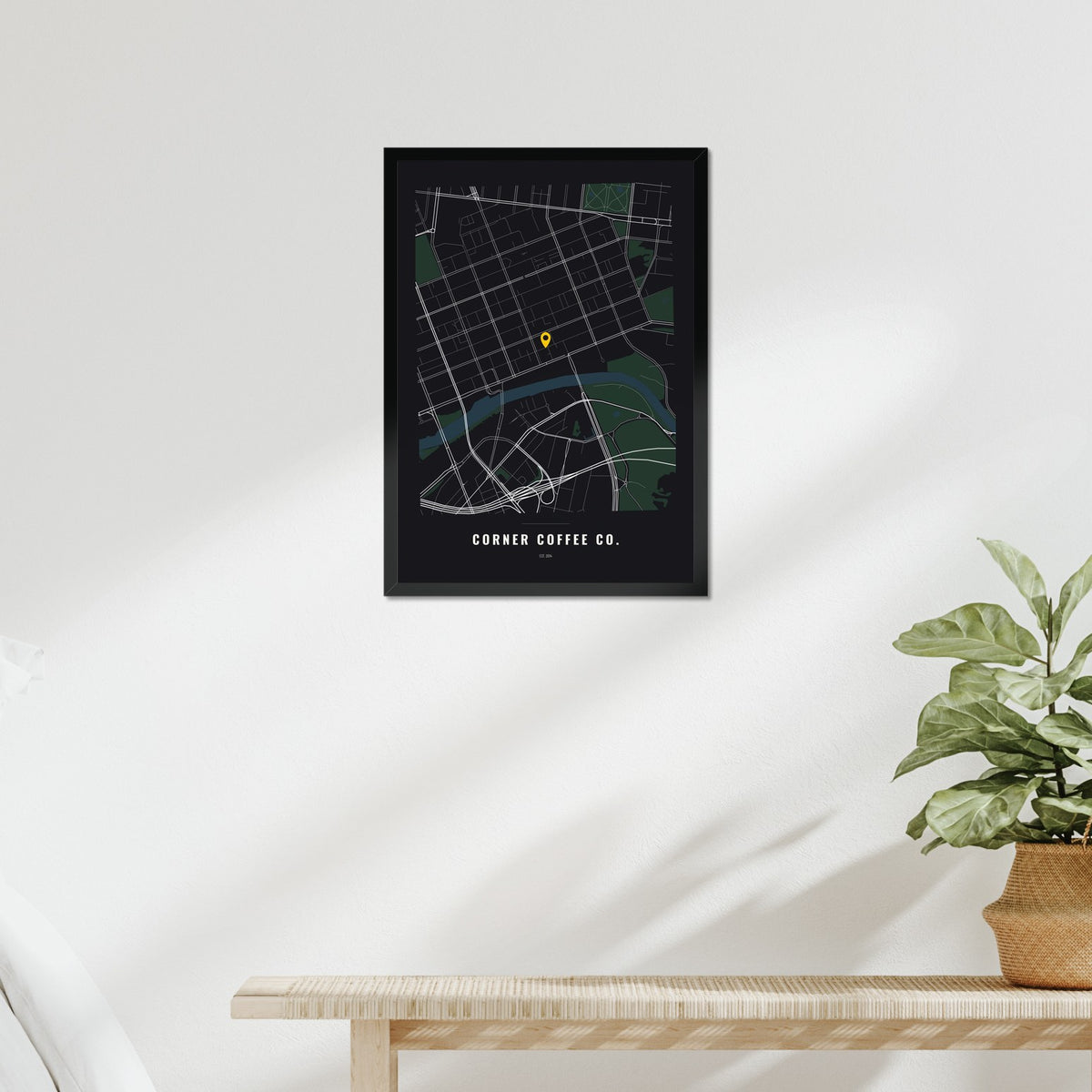 Business Location Map poster in a black frame above a bed