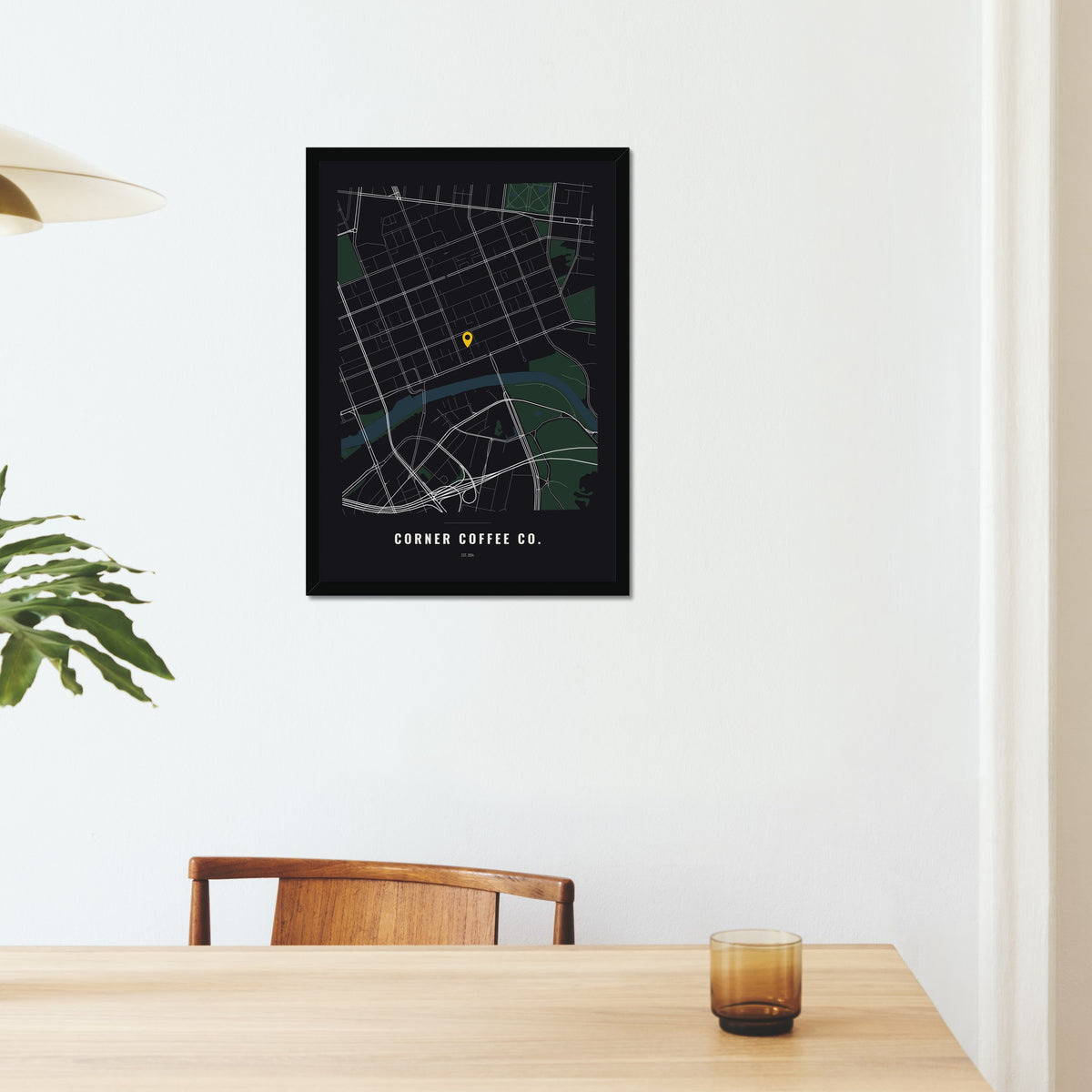 Business Location Map poster in a black frame on a dining room wall
