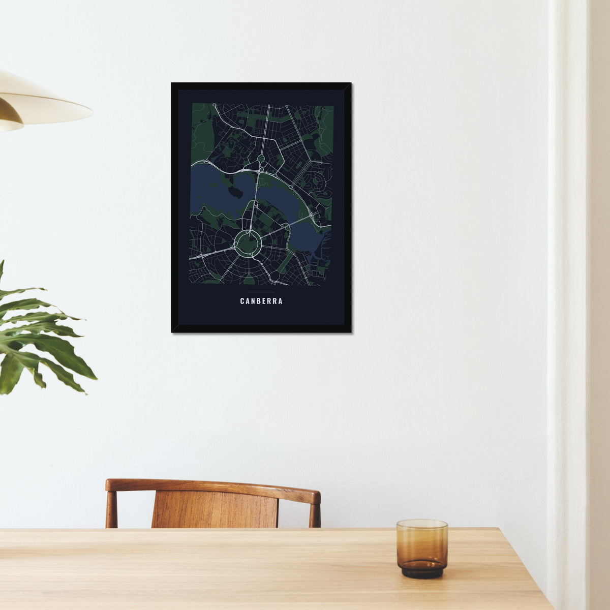 Canberra City Map poster in a black frame on a dining room wall