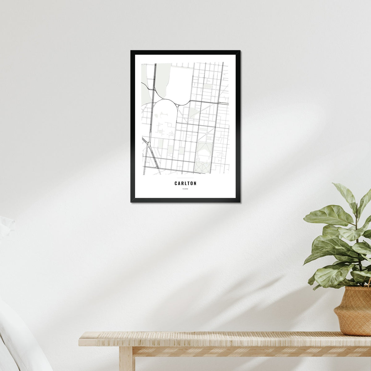 Carlton Map poster in a black frame above a bed