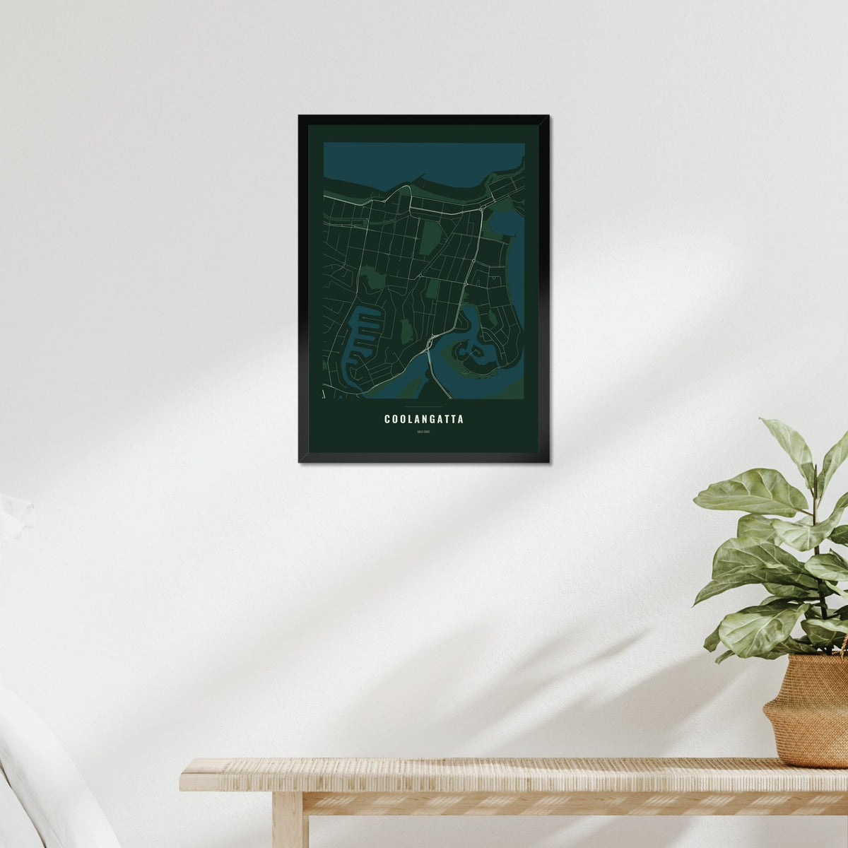 Coolangatta Map poster in a black frame above a bed