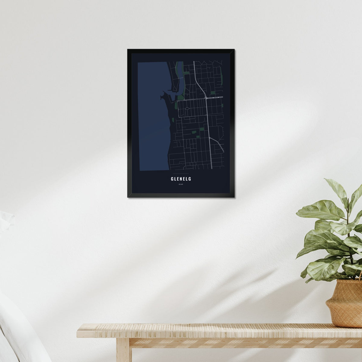 Glenelg Map poster in a black frame above a bed
