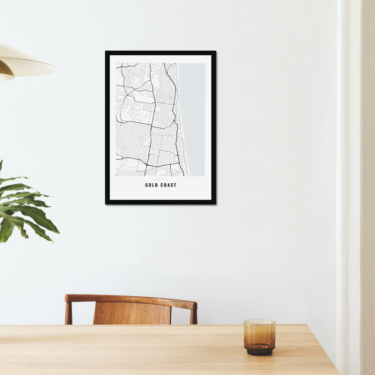 Gold Coast City Map poster in a black frame on a dining room wall
