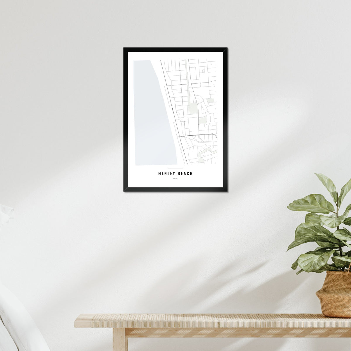 Henley Beach Map poster in a black frame above a bed