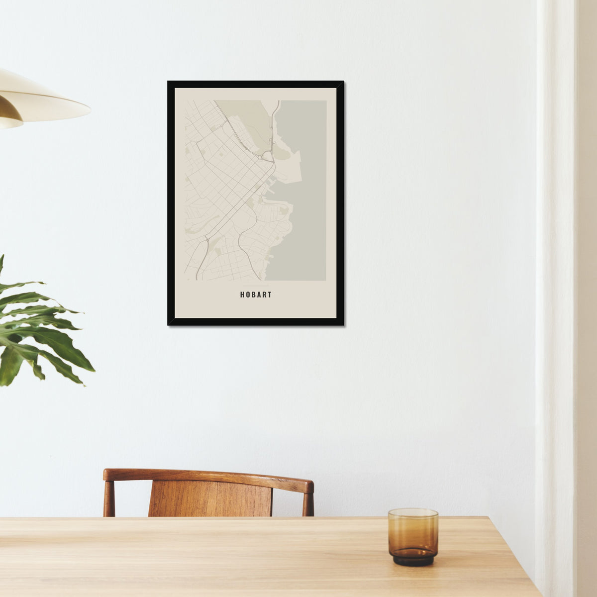 Hobart City Map poster in a black frame on a dining room wall