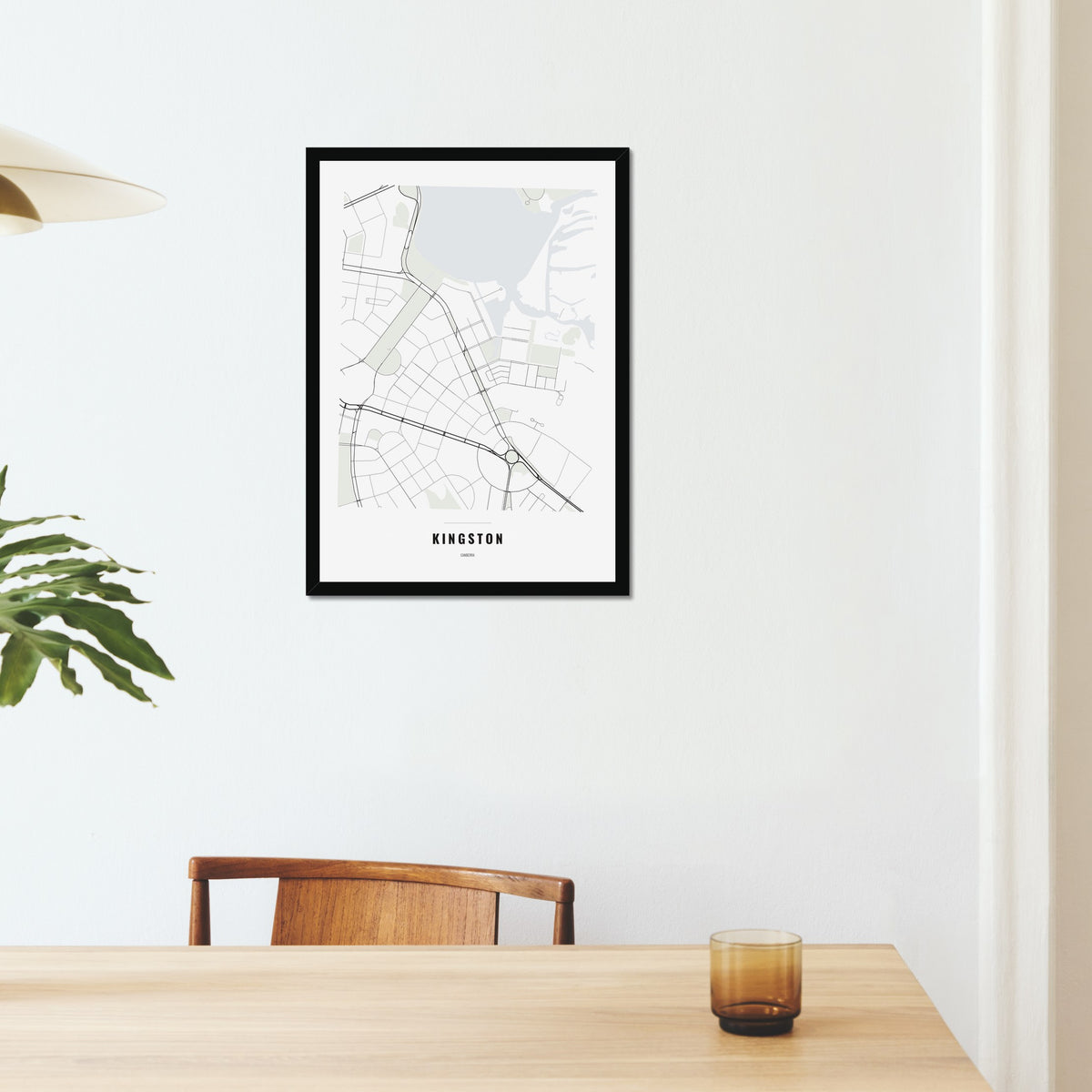 Kingston Map poster in a black frame on a dining room wall