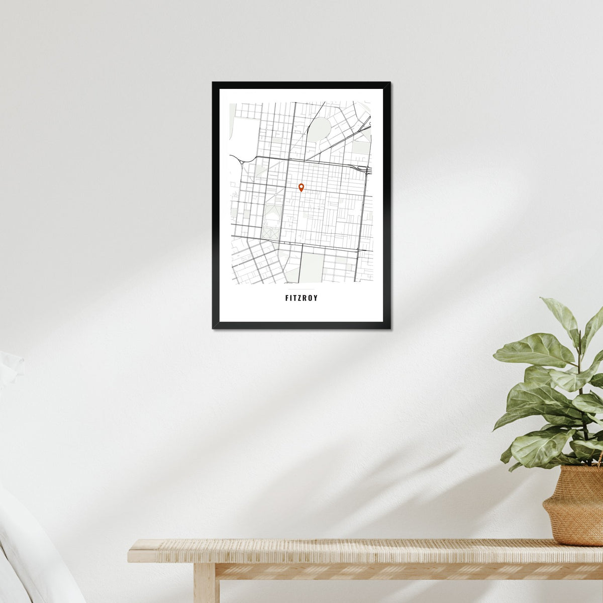Local Area Map poster in a black frame above a bed