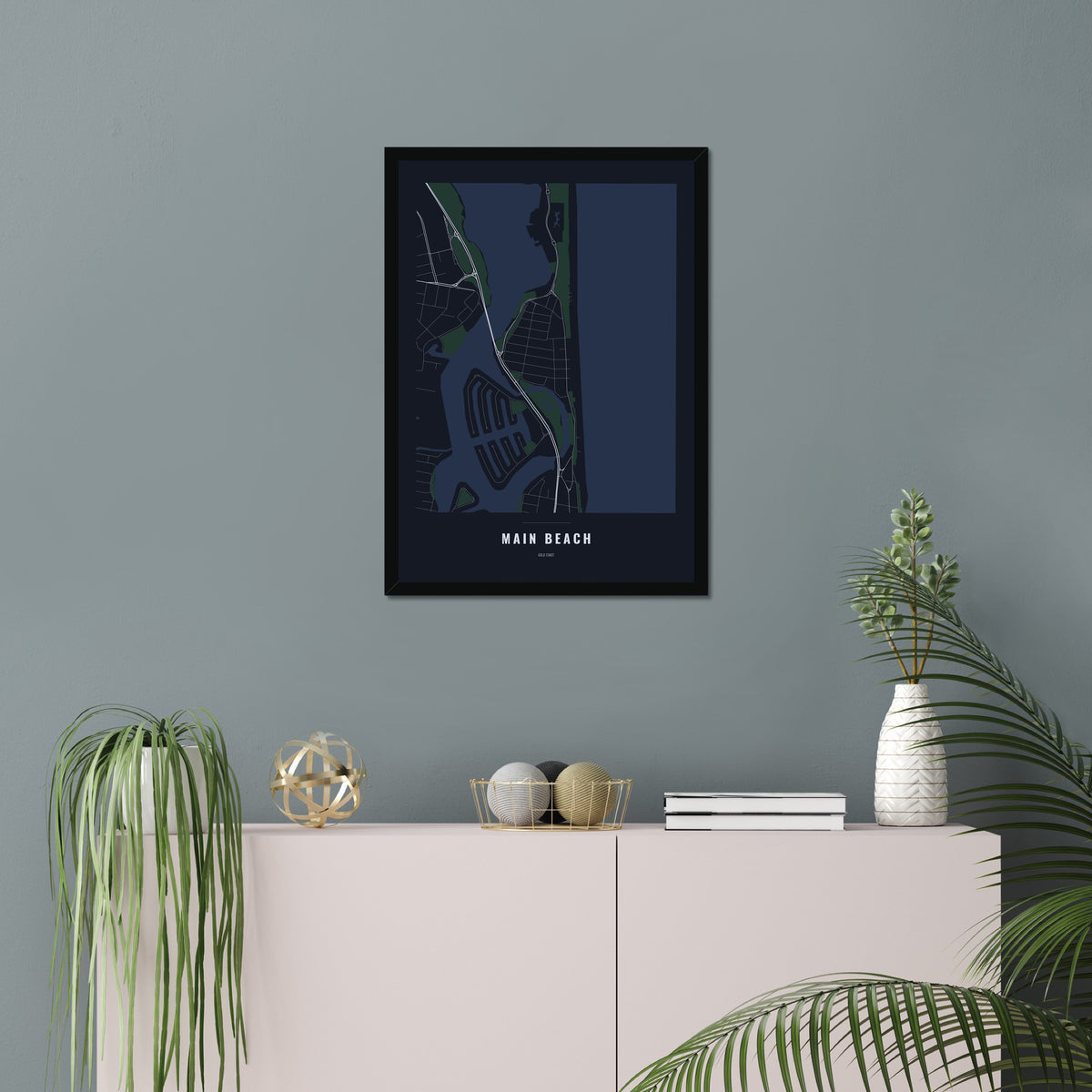 Main Beach Map poster in a black frame in a living room