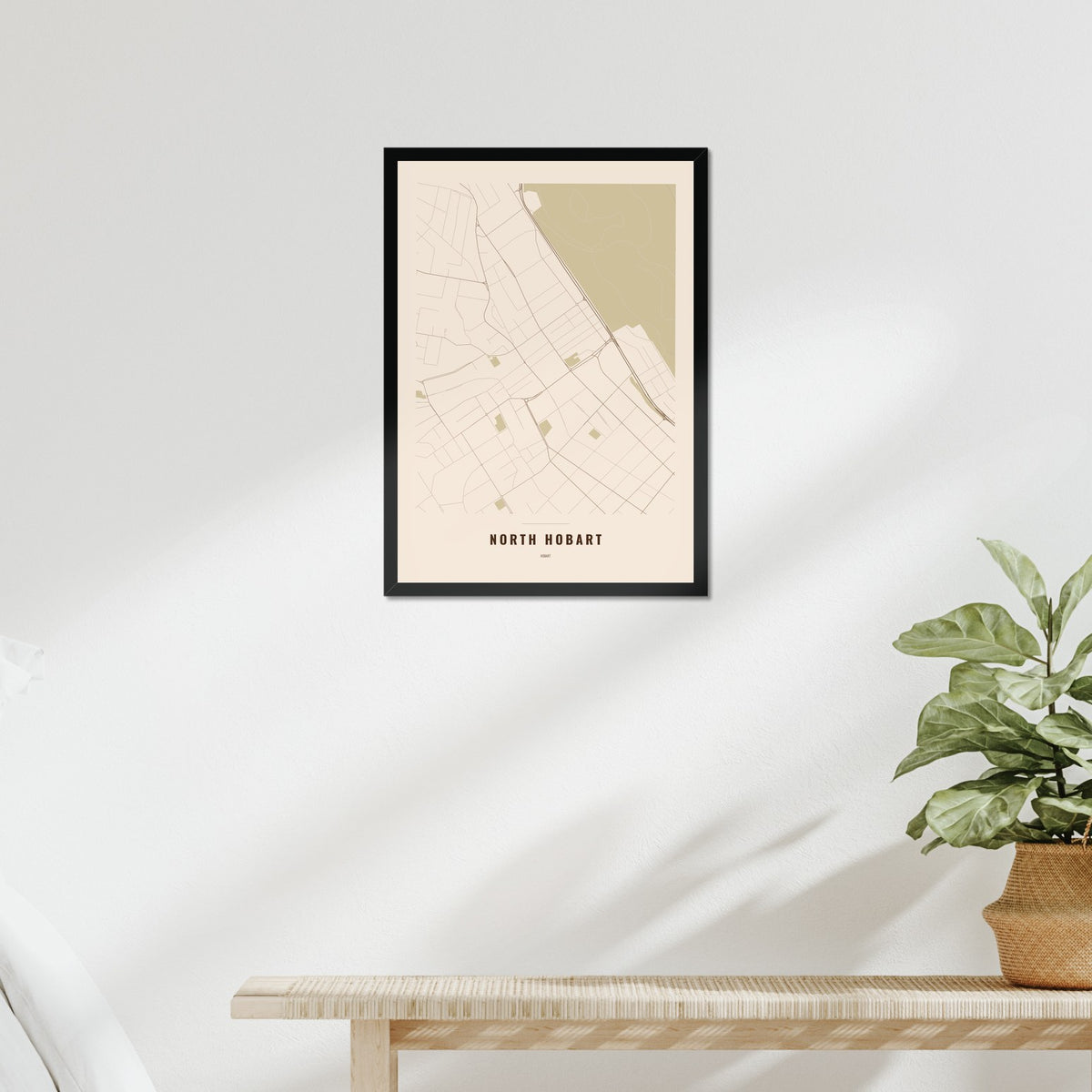 North Hobart Map poster in a black frame above a bed