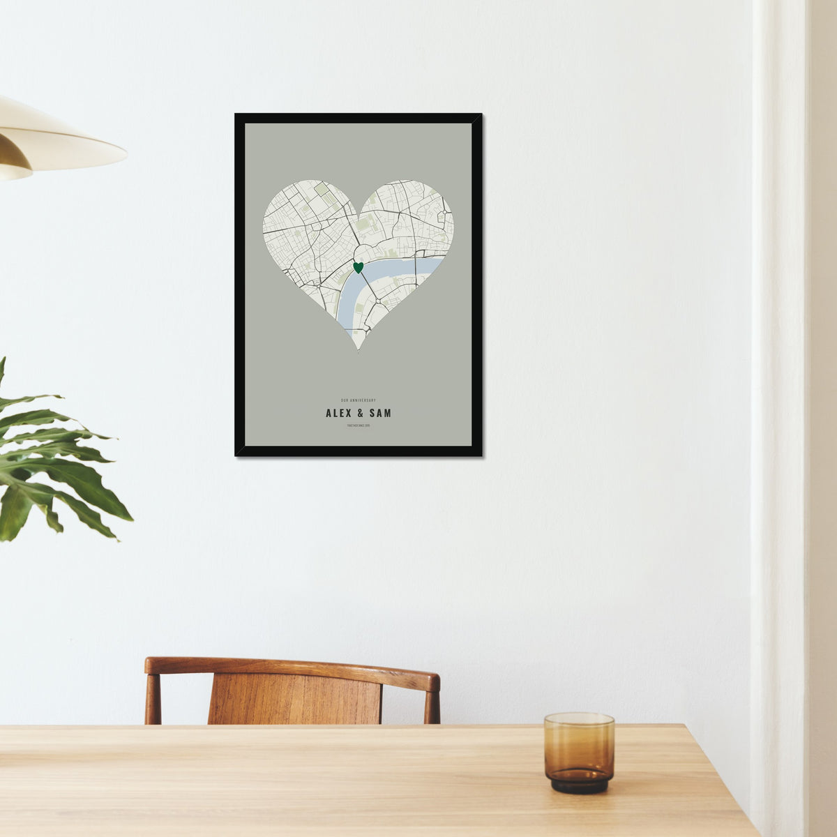 Our Anniversary Map poster in a black frame on a dining room wall