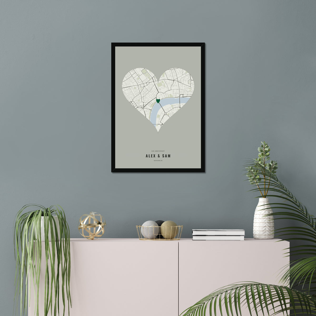 Our Anniversary Map poster in a black frame in a living room
