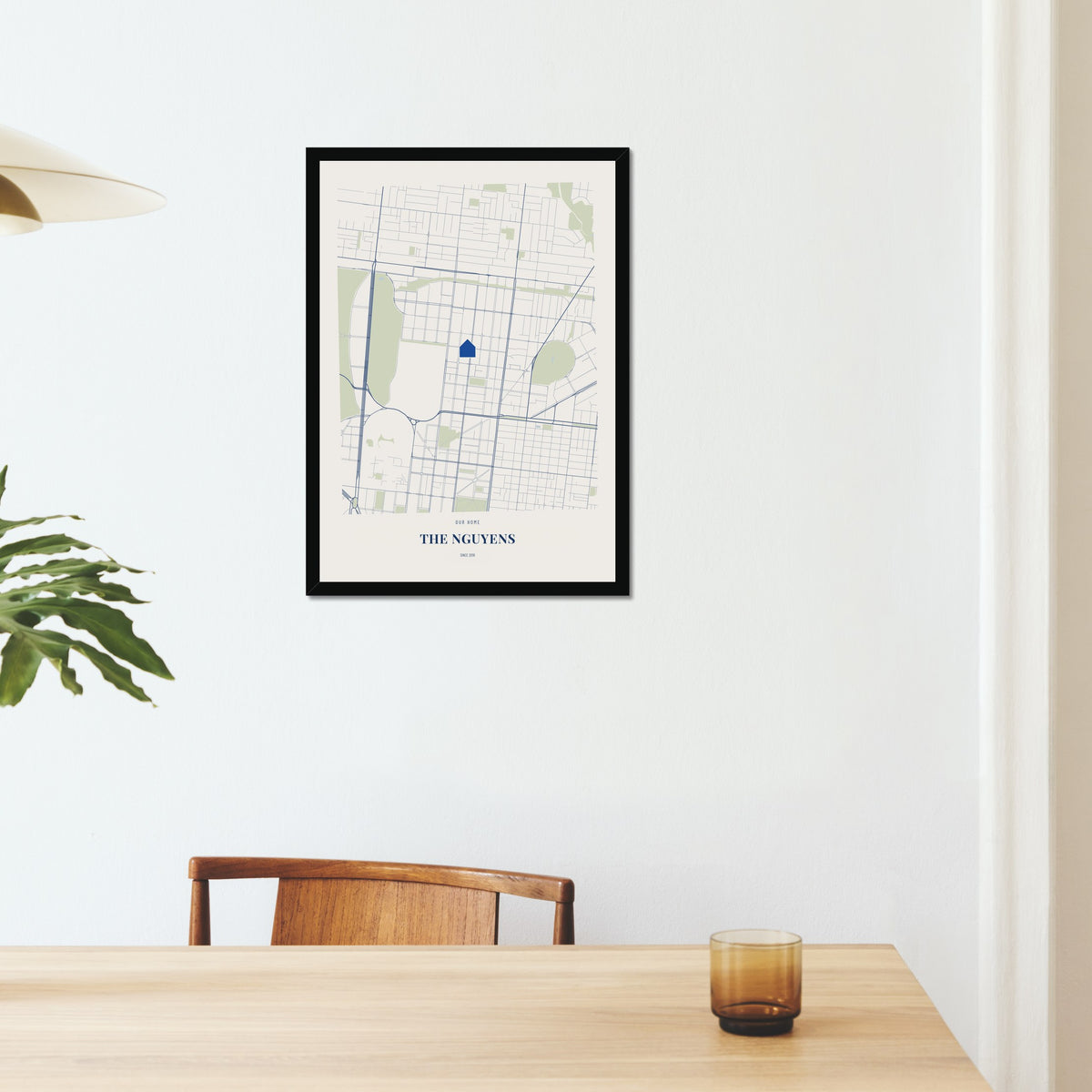 Our Home Map poster in a black frame on a dining room wall