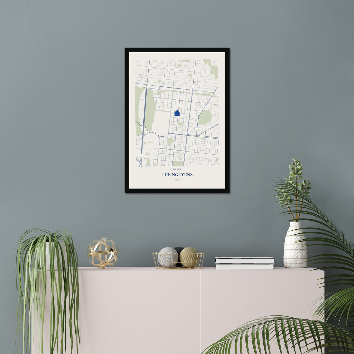 Our Home Map poster in a black frame in a living room