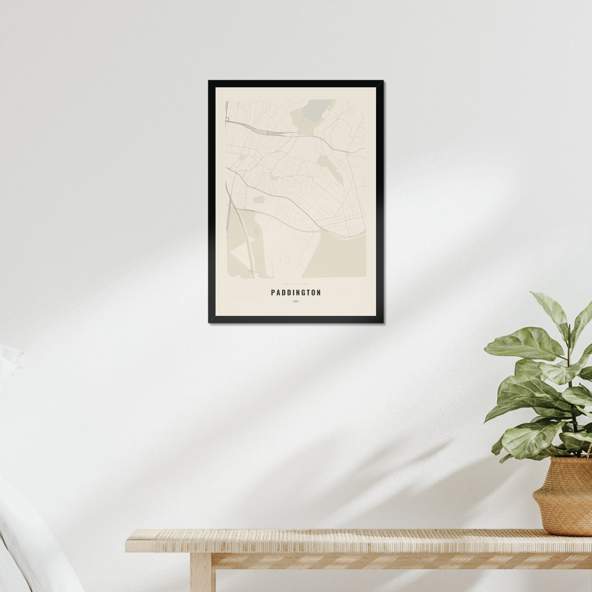 Paddington Map poster in a black frame above a bed