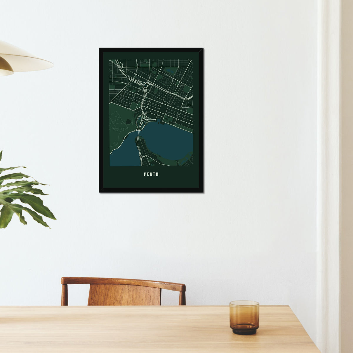Perth City Map poster in a black frame on a dining room wall