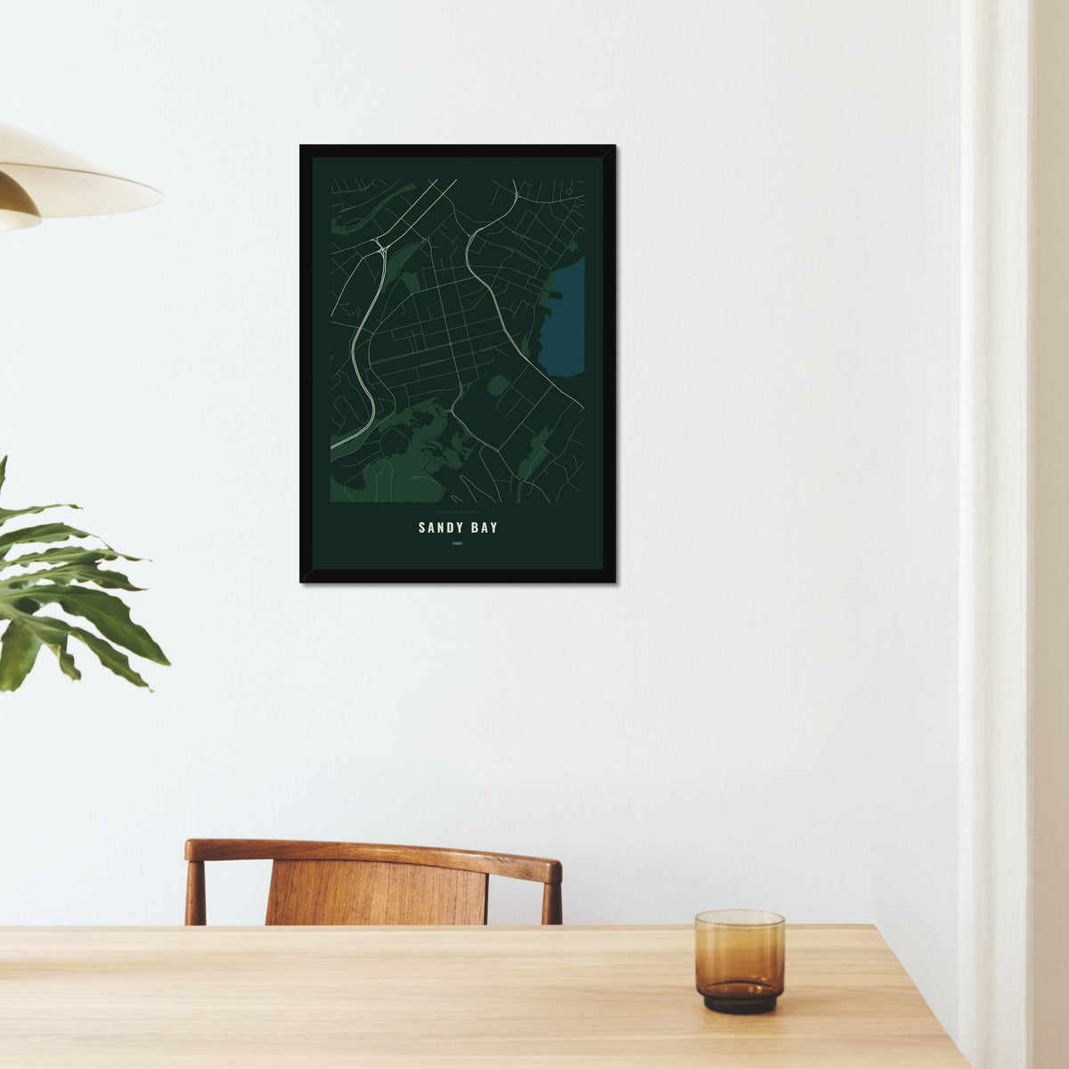 Sandy Bay Map poster in a black frame on a dining room wall