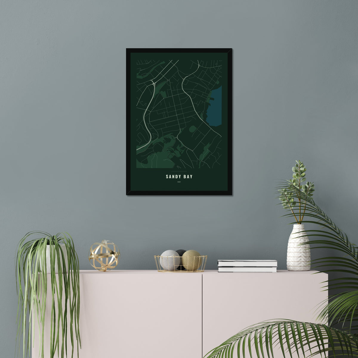 Sandy Bay Map poster in a black frame in a living room