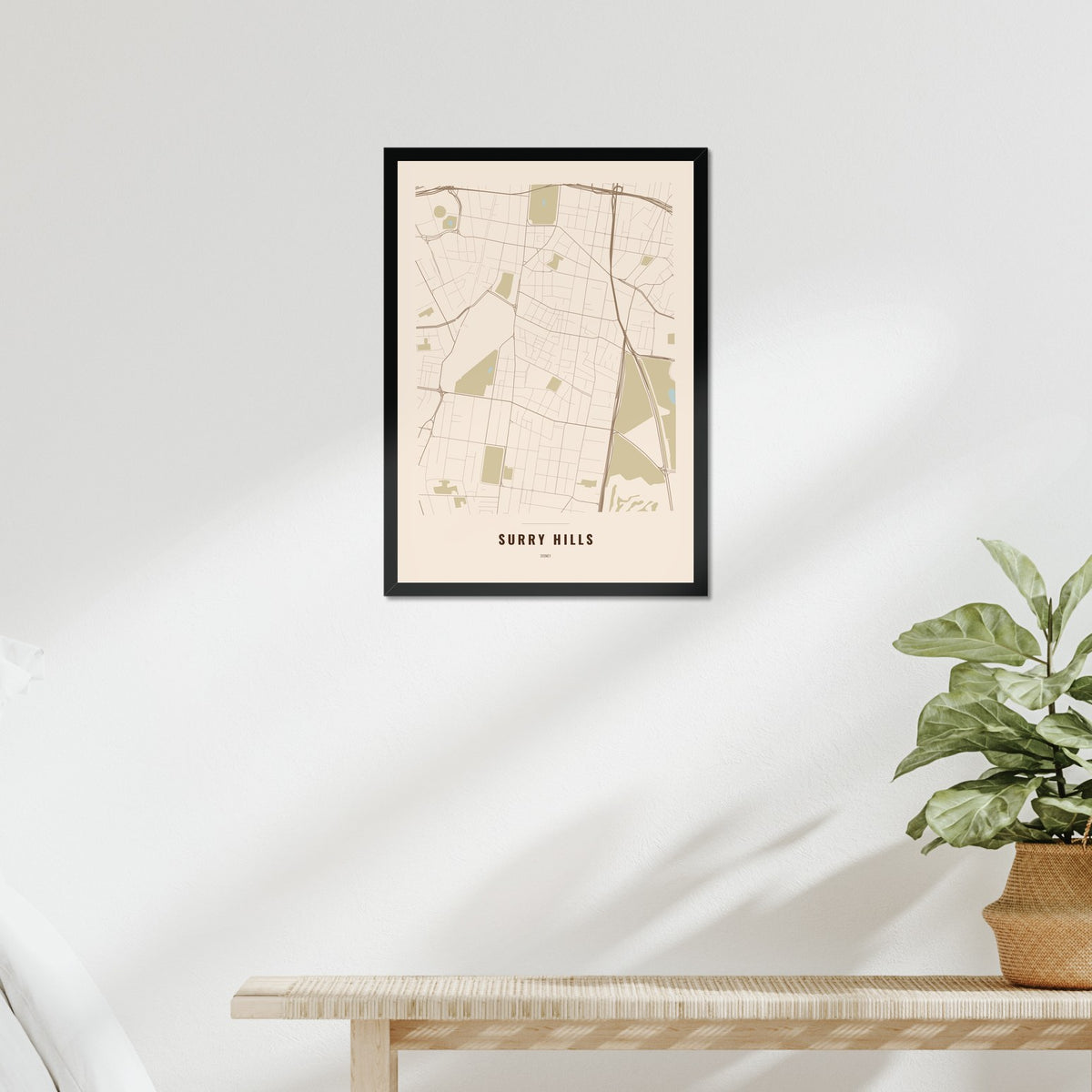 Surry Hills Map poster in a black frame above a bed